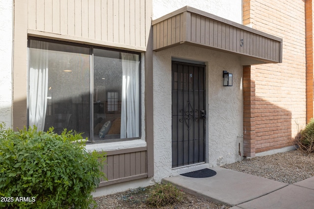 property entrance with stucco siding