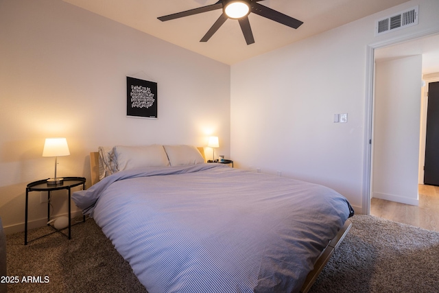 bedroom featuring baseboards, visible vents, and ceiling fan