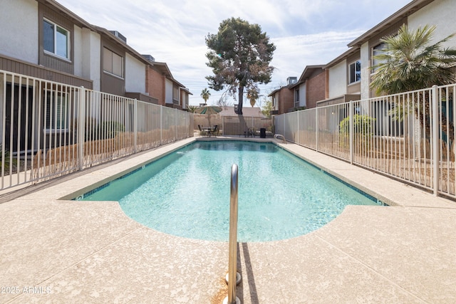 pool with a patio area and a fenced backyard