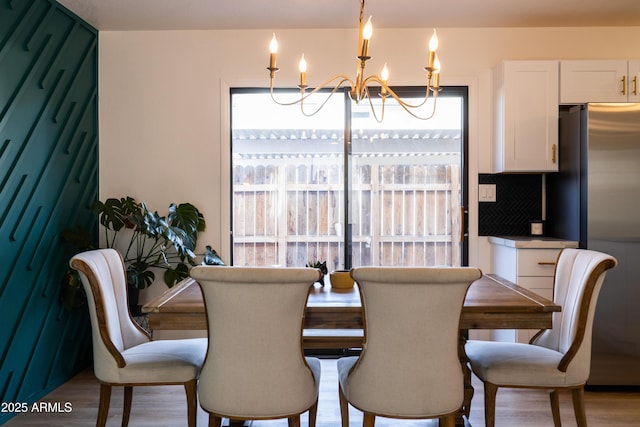 dining space with an inviting chandelier and wood finished floors