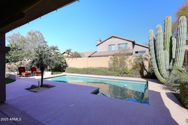 view of swimming pool with a patio, a fenced in pool, and fence