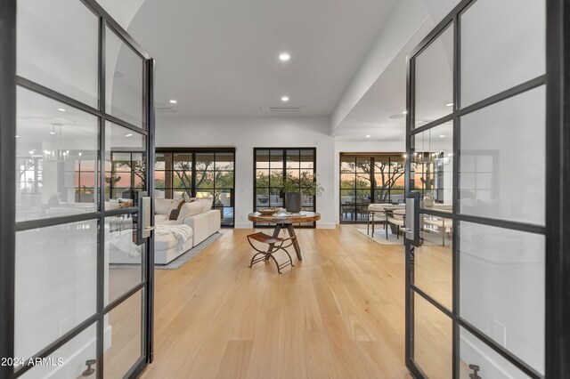 interior space with a notable chandelier and light hardwood / wood-style flooring