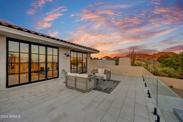 patio terrace at dusk with an outdoor living space