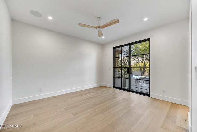 unfurnished room featuring ceiling fan and light wood-type flooring