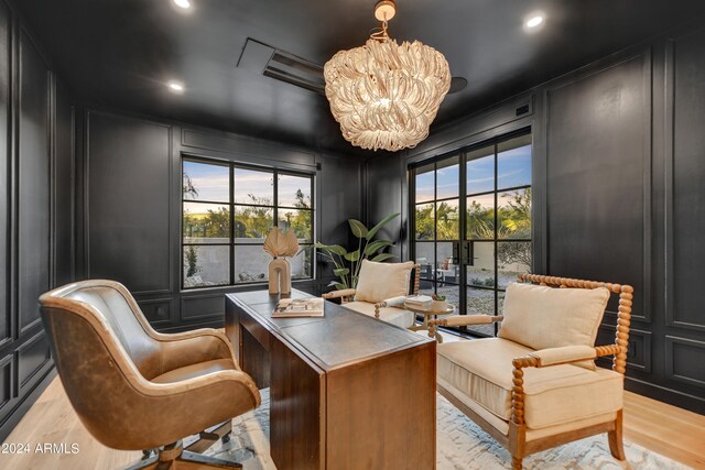 office area featuring light wood-type flooring and a chandelier