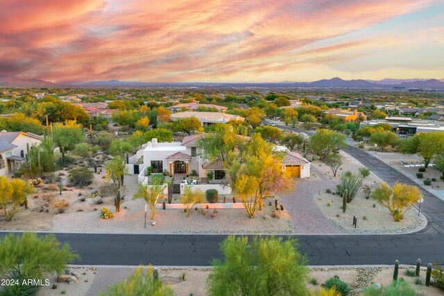 aerial view at dusk featuring a mountain view