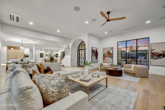 living room with ceiling fan and light hardwood / wood-style floors