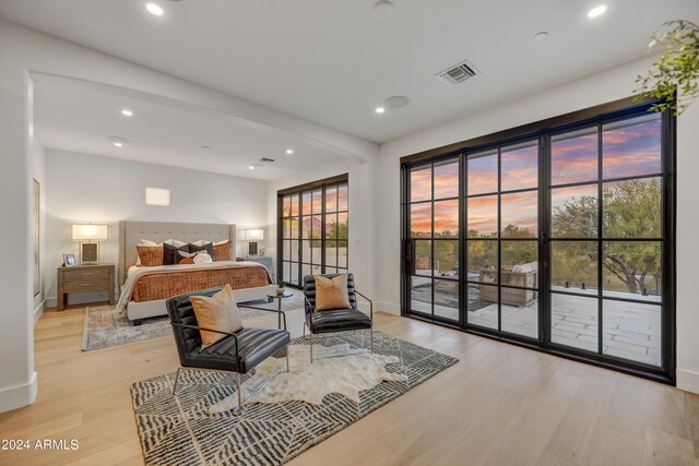 bedroom with light wood-type flooring and access to outside