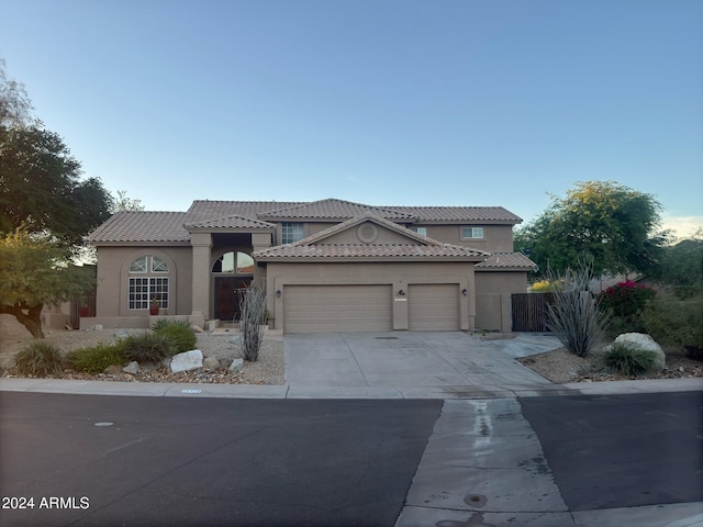 mediterranean / spanish house featuring a garage