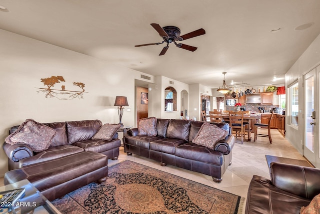 living room with ceiling fan and light tile patterned flooring