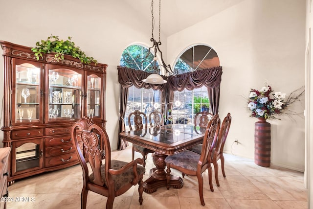 dining room with high vaulted ceiling