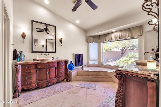 bathroom with ceiling fan, vanity, tiled bath, vaulted ceiling, and tile patterned floors