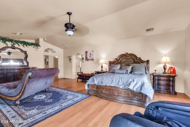 bedroom featuring ceiling fan, wood-type flooring, and vaulted ceiling