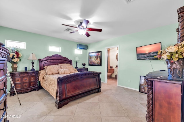 bedroom with light tile patterned flooring, ensuite bath, and ceiling fan