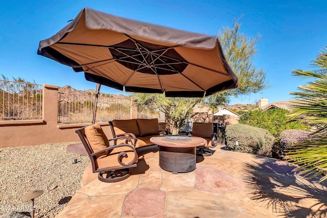 view of patio featuring an outdoor living space with a fire pit