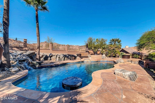 view of pool with pool water feature and a patio