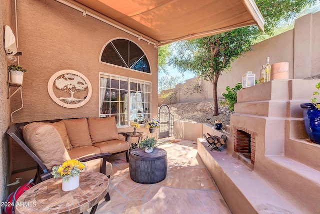 view of patio featuring an outdoor living space with a fireplace