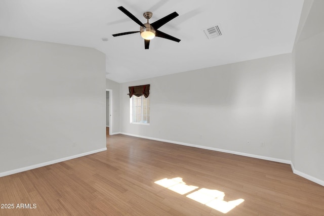 spare room with vaulted ceiling, ceiling fan, and light hardwood / wood-style floors