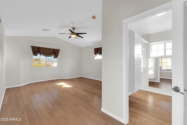 spare room featuring ceiling fan, vaulted ceiling, and light wood-type flooring