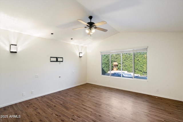 empty room with ceiling fan, dark hardwood / wood-style flooring, and vaulted ceiling