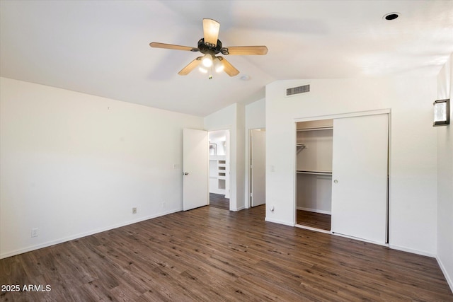 unfurnished bedroom featuring ceiling fan, dark wood-type flooring, a closet, and lofted ceiling