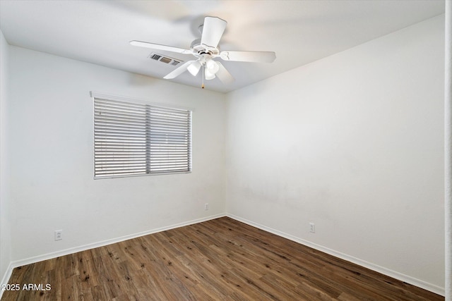 empty room featuring ceiling fan and dark hardwood / wood-style flooring