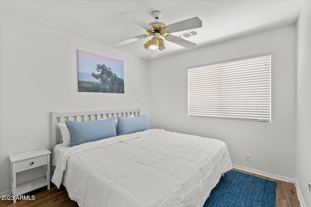 bedroom featuring ceiling fan and dark hardwood / wood-style flooring