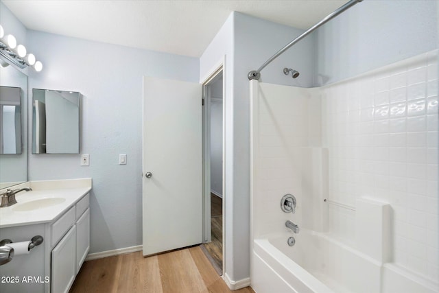 bathroom featuring bathtub / shower combination, wood-type flooring, and vanity