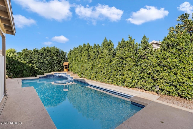 view of swimming pool featuring an outdoor fireplace