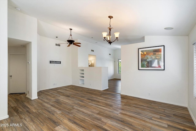 unfurnished living room with dark hardwood / wood-style flooring, lofted ceiling, and ceiling fan with notable chandelier