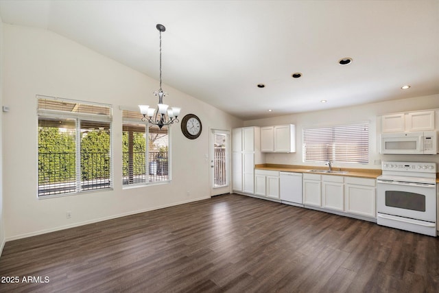 kitchen with an inviting chandelier, white cabinetry, white appliances, dark hardwood / wood-style flooring, and sink