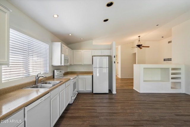 kitchen with dark wood-type flooring, sink, white appliances, and white cabinets