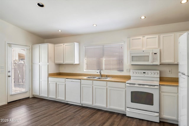 kitchen featuring lofted ceiling, sink, white appliances, white cabinetry, and dark wood-type flooring