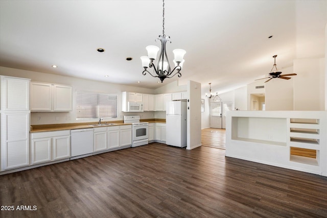 kitchen with white cabinetry, white appliances, dark hardwood / wood-style flooring, hanging light fixtures, and vaulted ceiling