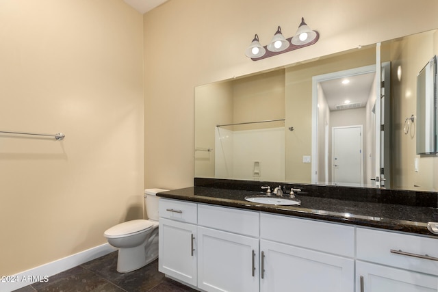 bathroom featuring tile patterned flooring, vanity, toilet, and a shower