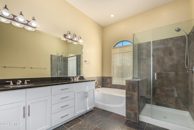 bathroom with vanity and separate shower and tub