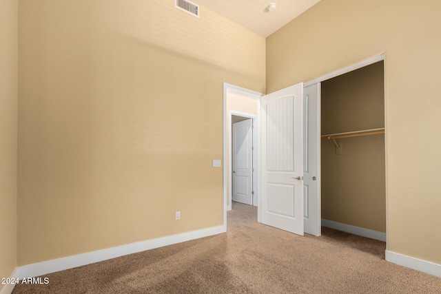 unfurnished bedroom with carpet floors and a closet