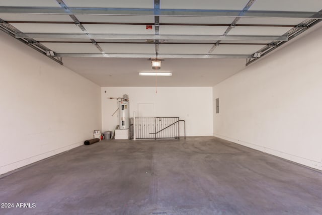 garage featuring electric water heater and electric panel