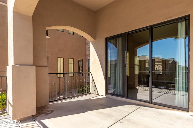 view of exterior entry featuring a patio