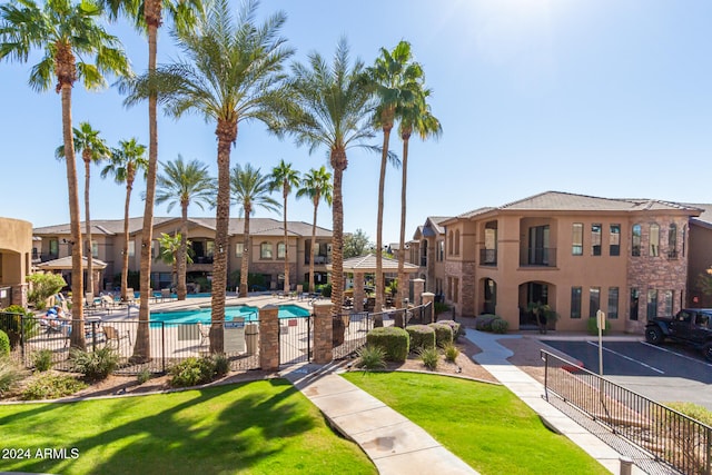 view of swimming pool featuring a patio and a yard