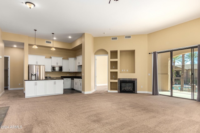 unfurnished living room featuring light colored carpet