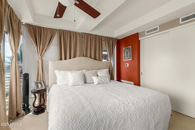 carpeted bedroom with a closet and a ceiling fan