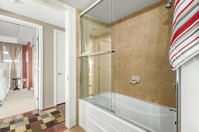 bathroom with shower / bath combination with glass door