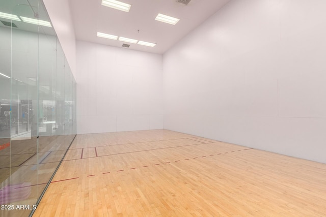 surrounding community with high vaulted ceiling and a sport court