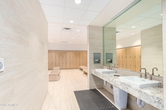 full bathroom featuring a sink, a drop ceiling, recessed lighting, and tile patterned flooring