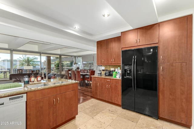 kitchen with black refrigerator with ice dispenser, dishwasher, healthy amount of natural light, decorative backsplash, and recessed lighting