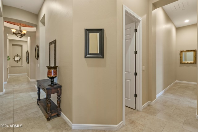 hallway featuring an inviting chandelier