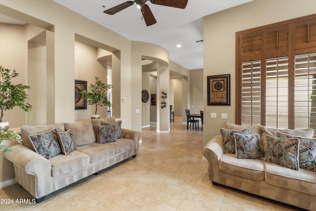 tiled living room featuring ceiling fan