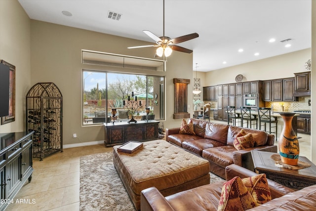 living room with light tile patterned floors and ceiling fan