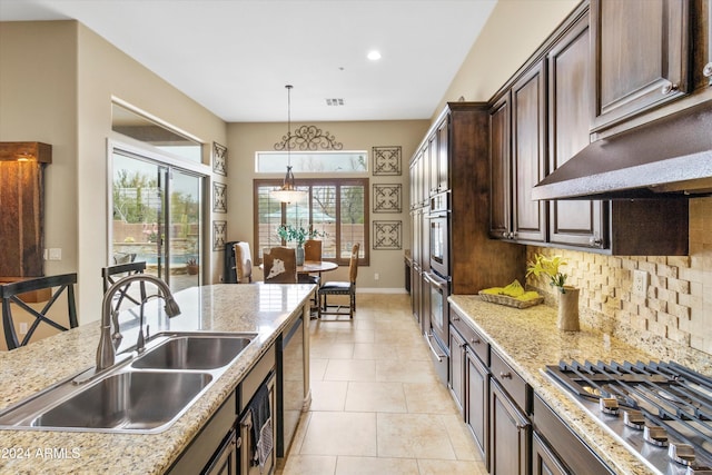 kitchen featuring light stone countertops, sink, stainless steel appliances, and dark brown cabinets